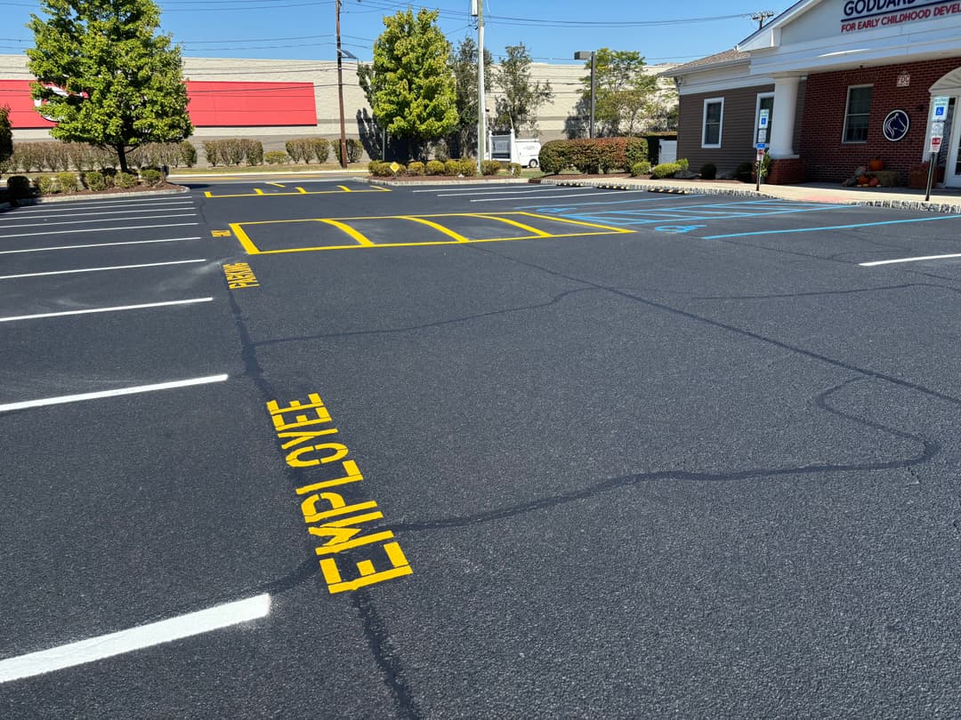 Parking lot with marked employee spaces and painted lines for customer parking.